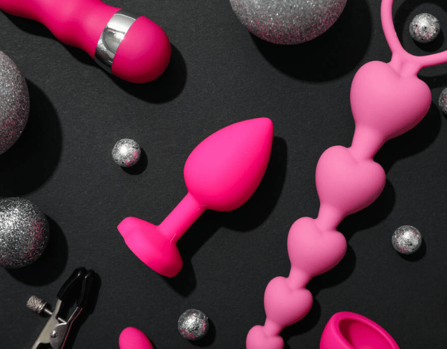 Multiple pink sex toys image with black background