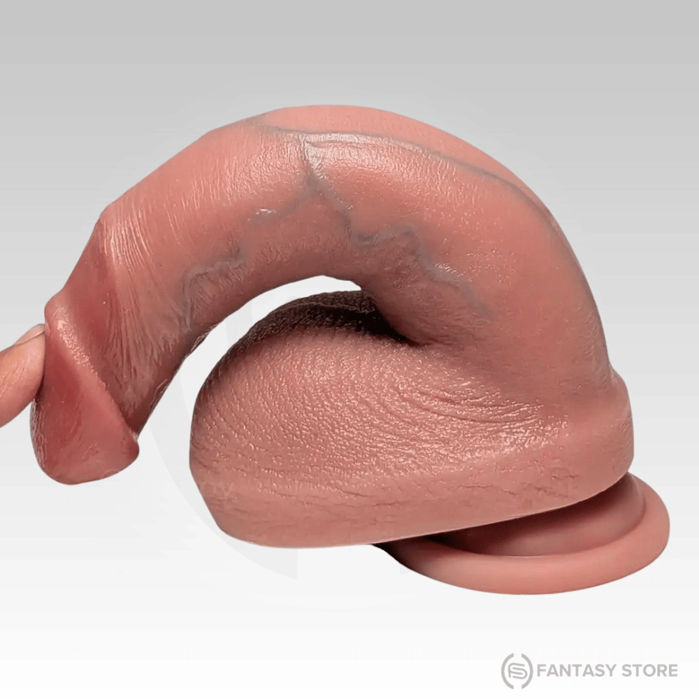 Bendable realistic dildo showing flexible body-safe silicone construction.